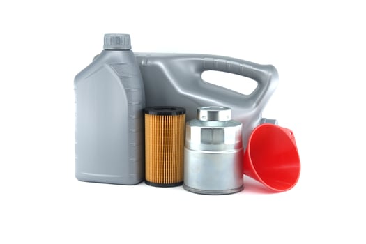 Oil containers and automotive filters are displayed on a white, illustrating car maintenance tools photo