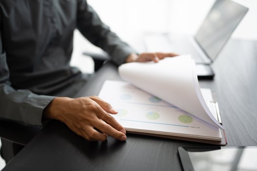Asian business man holding paper document calculating tax insurance managing budget. photo