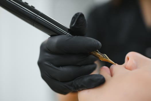 Young woman undergoing procedure of permanent lip makeup in tattoo salon photo