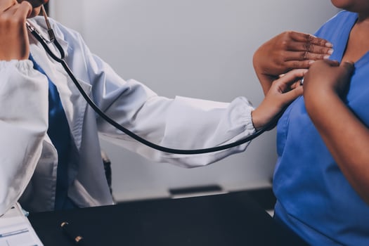 Female doctor use stethoscope to examine eldely paient heartbeat photo