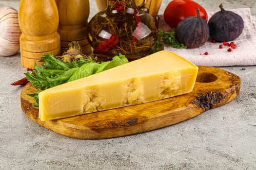 Hard parmesan cheese triangle over board photo