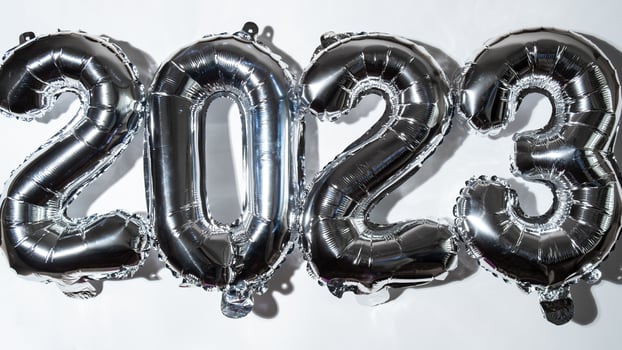Happy new year 2023 metallic balloons on white background. Greeting card silver foil balloons numbers Christmas holiday concept. Celebration party congratulation decoration photo