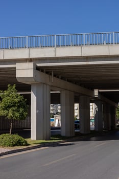Urban infrastructure features an elevated road structure on a clear day in a busy city photo