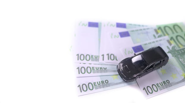 Model car with euro banknotes on white background concept of saving for buying car, car loan and car insurance. photo