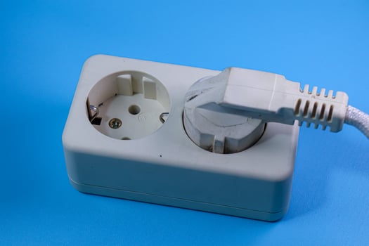 socket and plug isolated on blue photo
