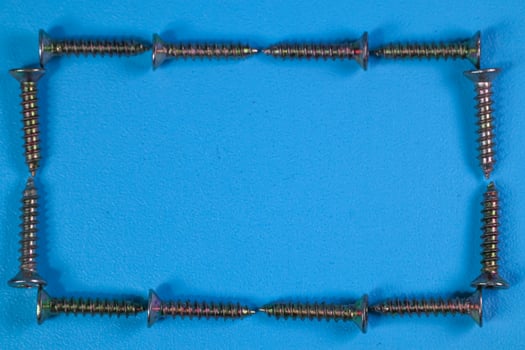 group of screws forming a frame isolated on a blue background photo