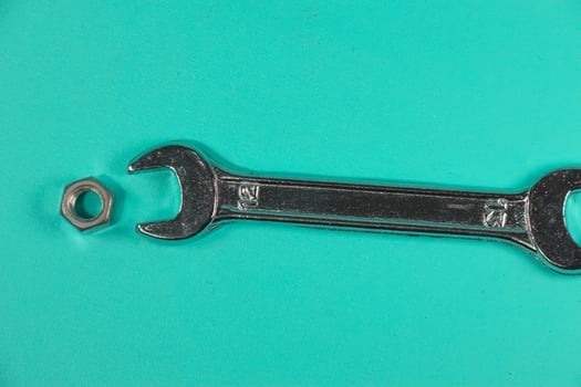 nuts hexagon and wrench on green background, photo