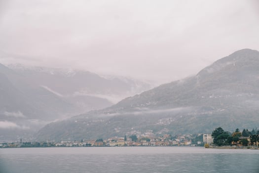 Foggy mountainous coast with colorful villas of Lake Como. Italy photo