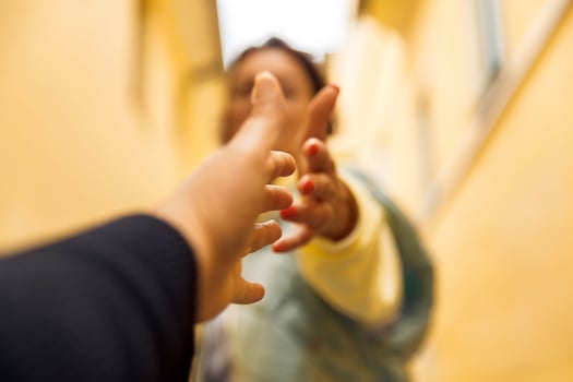 Reaching hands in motion - symbolizing connection and support in a vibrant urban setting photo