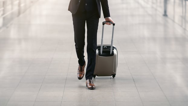 Business Trip Concept. Unrecognizable Businessman Moving To Terminal Gate At Airport, Front View. Free space photo