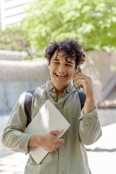 Young student walking and talking on the phone photo