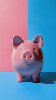 A cute pink piggy bank stands on a vibrant blue and pink background during daytime photo