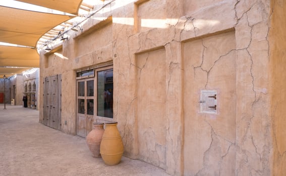 Narrow streets that create shade on a hot day in the old city of Dubai Creek and Bur district. Travel destinations and heritage village photo