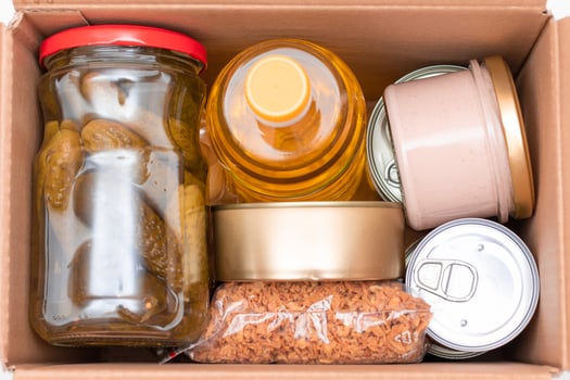 Food Reserves or Donation Box. Carton Box with Canned Food, Cereals and Grocery. Emergency Food Storage in Case of Crisis. Free Social Help, Blessings and Care. Strategic Food Supplies photo
