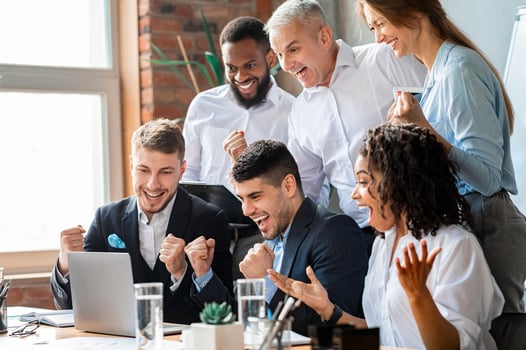Happy Business People At Laptop Celebrating Success At Work Sitting In Modern Office. Successful Negotiations photo
