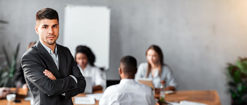 Business Leadership. Serious Businessman Standing Crossing Hands In Front Of His Business Team In Modern Office. photo