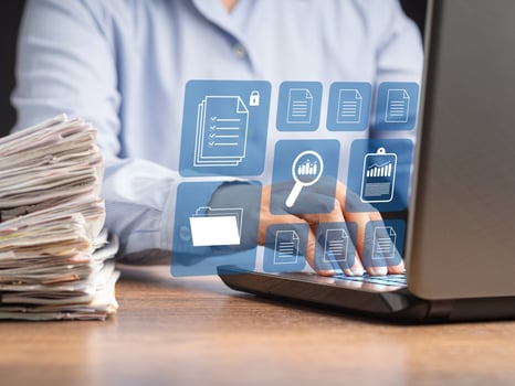 Businessman working at a laptop and digital documents on a virtual screen photo