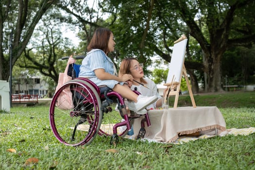 Close Friends, Disabled Young Women Drawing Together Outdoors in a Park, Embracing Creativity and Friendship photo