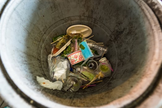 Overflowing Trash Bin with Food Containers and Plastic Items photo