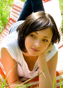 young girl laying on a field photo
