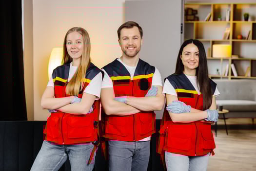 Group of people with cpr dummy looking at camera and smiling after first aid training class photo