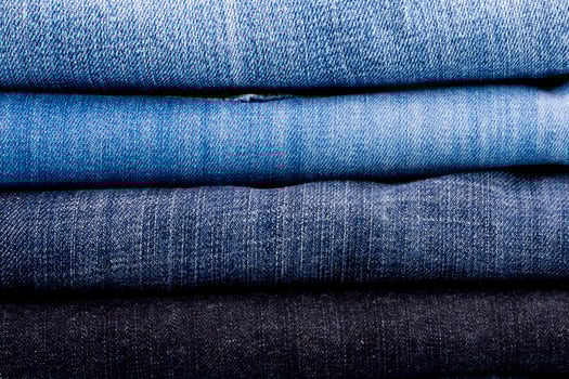 stack of blue jeans photo