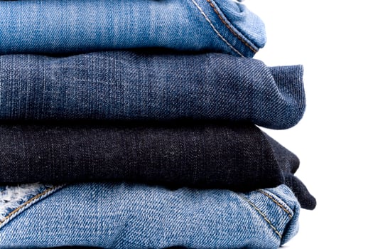 stack of blue jeans photo