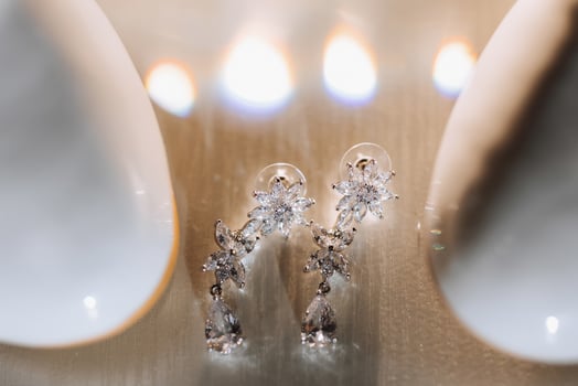 The earrings are made of silver and have a flower design photo