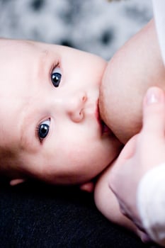 newborn baby near mother's breast photo