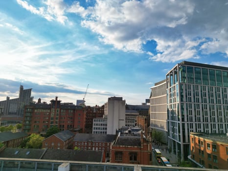 Iconic Buildings at Central Greater Manchester City Centre and Tall Buildings During Golden Hour of Sunset over England UK. Aerial Footage Was Captured with Drone's Camera on May 5th, 2024. photo