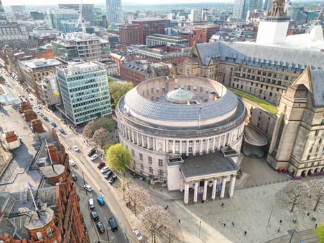 Iconic Buildings at Central Greater Manchester City Centre and Tall Buildings During Golden Hour of Sunset over England UK. Aerial Footage Was Captured with Drone's Camera on May 5th, 2024. photo