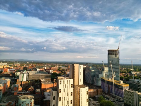Iconic Buildings at Central Greater Manchester City Centre and Tall Buildings During Golden Hour of Sunset over England UK. Aerial Footage Was Captured with Drone's Camera on May 5th, 2024. photo