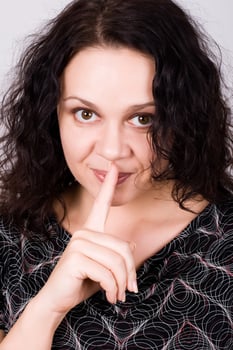 woman with finger on lips photo