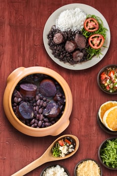 Traditional Brazilian feijoada with a red background photo