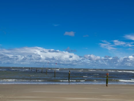 A blue sky with white clouds at the north sea in germany photo