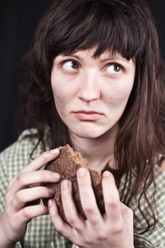 beggar woman with a piece of bread photo