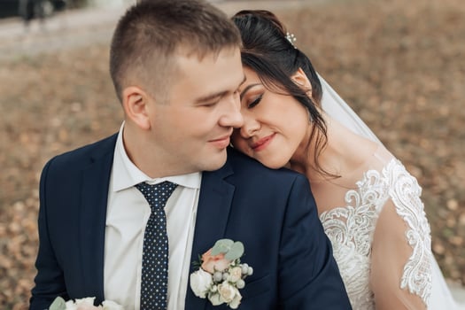 A man and woman are sitting on the ground, hugging each other photo