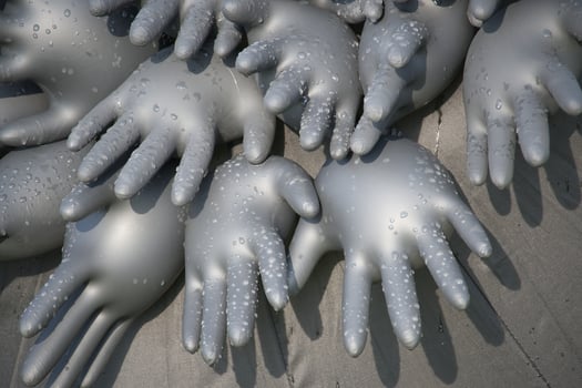 Collection of inflated rubber gloves covered in water droplets forms an abstract, artistic design photo