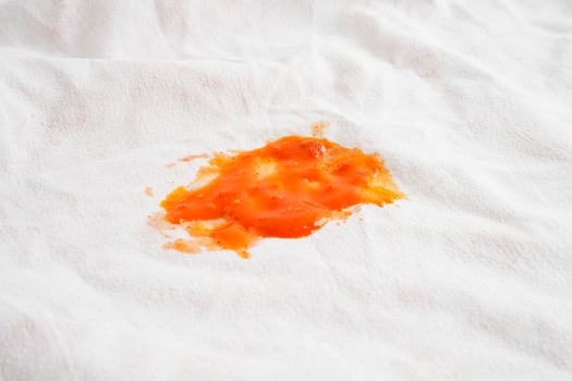 Dirty tomato sauce stain or ketchup on cloth to wash with washing powder, cleaning housework. photo