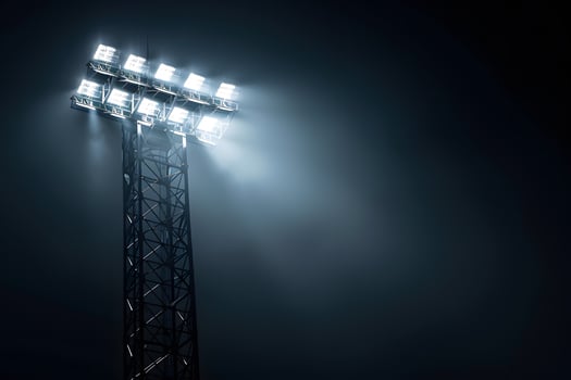 Bright Stadium Lights Shining in the Dark Night Sky photo