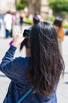 Young woman taking a photo