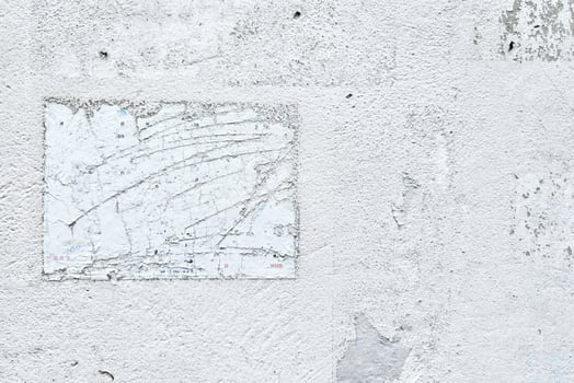 Peeling Poster left Glue Adhesive Stain on White Concrete wall. photo
