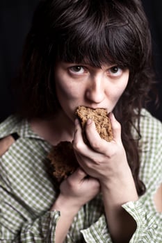 beggar woman eating bread photo