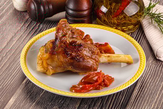 Baked lamb shank with vegetables photo