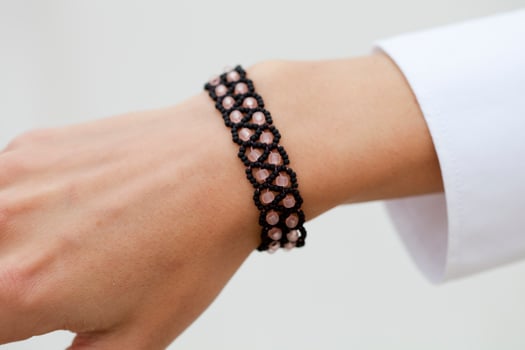 Stylish black bead bracelet on female hand photo