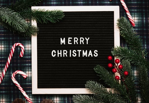 Merry Christmas lettering in plastic letters on an old vintage letter board. Top view. Flatley. Christmas greeting card. photo