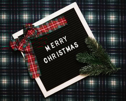 Merry Christmas lettering in plastic letters on an old vintage letter board. Top view. Flatley. Christmas greeting card. photo
