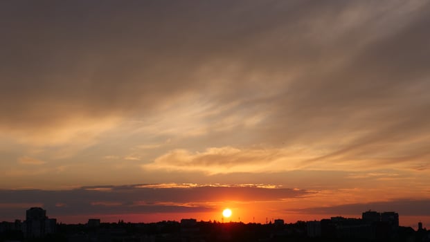 The sun sets over the city skyline photo