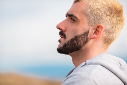 Side view of young bearded man. photo
