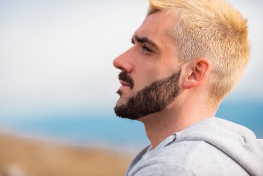 Side view of young bearded man blonde hair. photo